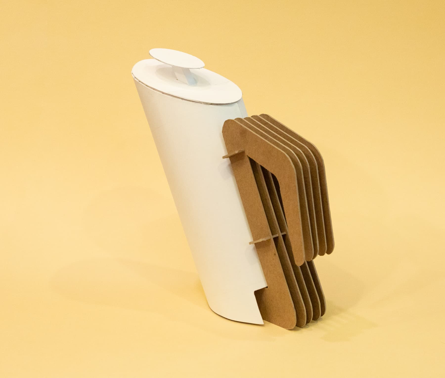 Back three-quarters view of the final French press model. The main container is made from layered Bristol paper and the handle is made of sheets of chipboard. 