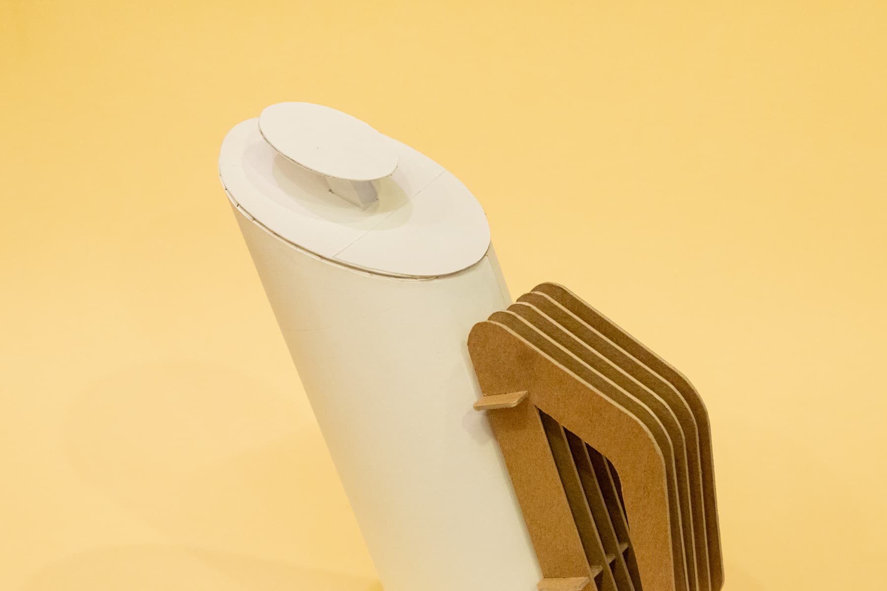 Close-up of the top of the model. The lid and plunger of the french press are both slanted at an angle.