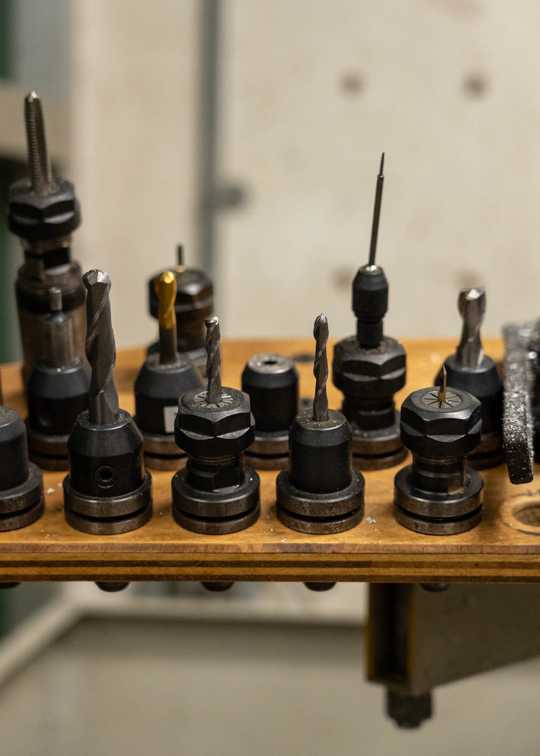 A collection of end mills for the CNC milling machine, varying greatly in height and shape.