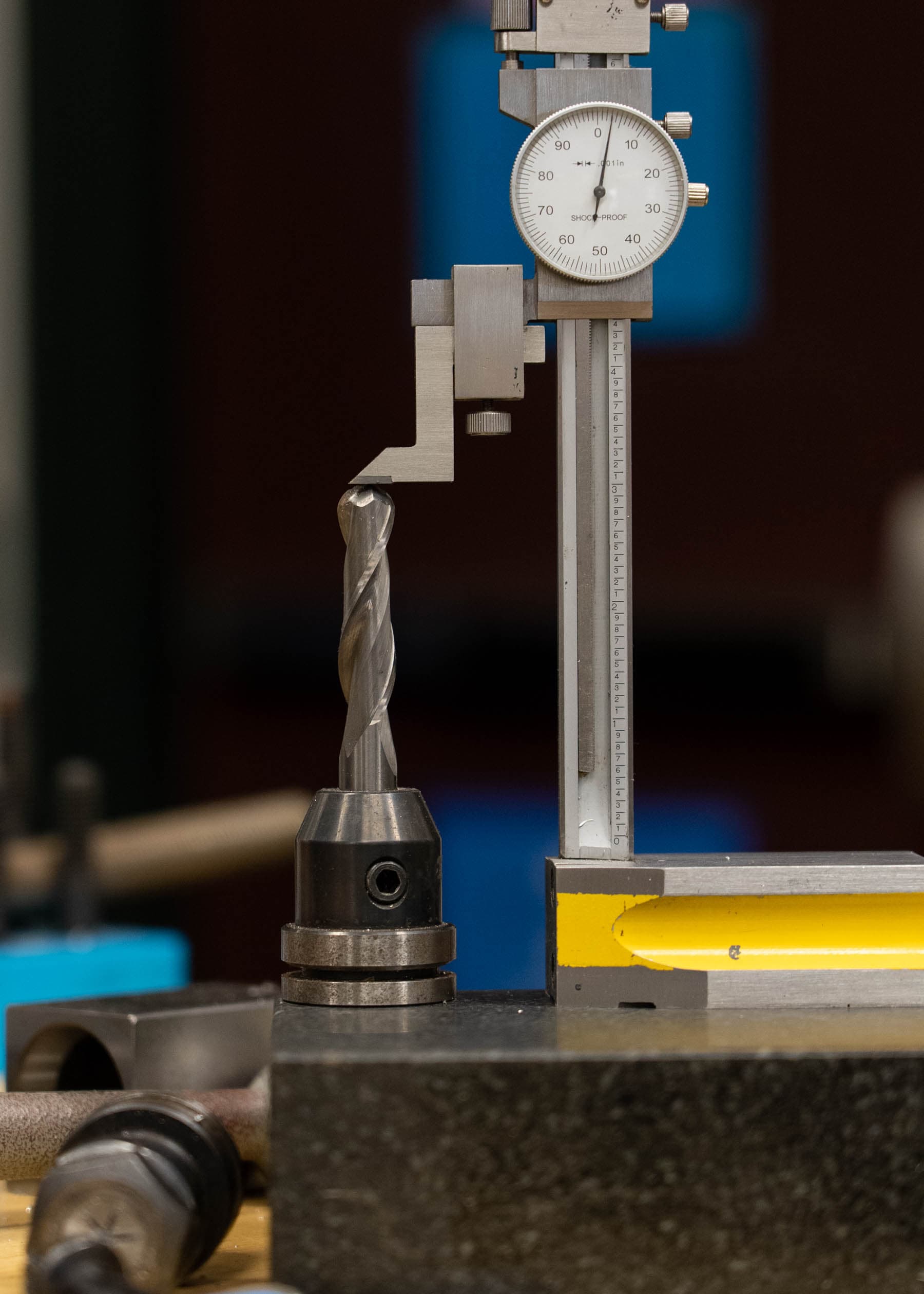 A half-inch ball end mill that is being measured on a flat marble surface with a height gauge.